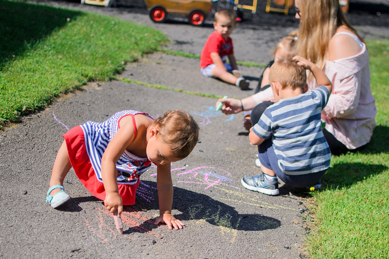Children drawing with sidewalk chalk